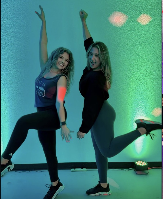 The Enough7Fitness duo striking a dance pose